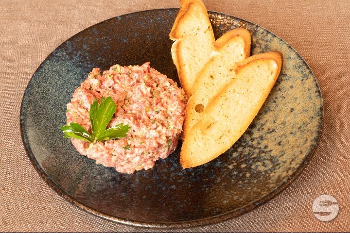 The classic beef tartare cut with a knife - Le Bistrot du Boucher