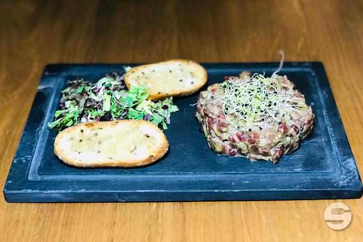 Grilled Beef Tartar with hazelnut oil and saladin - Face au Lac