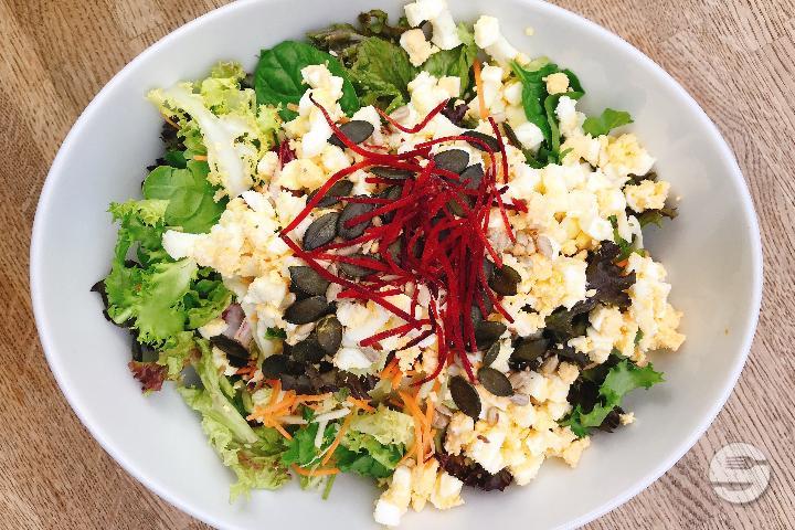 Salad with chopped egg and roasted seeds - Brauhaus