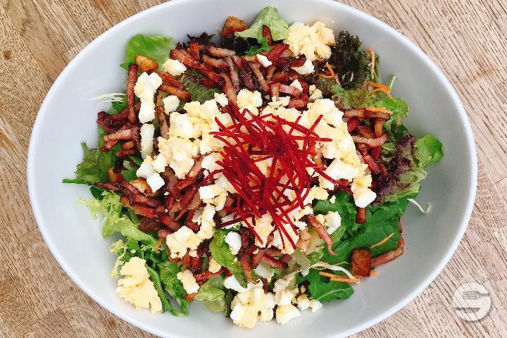 Salad with Thurgauer bacon, bagel croutons and egg - Brauhaus